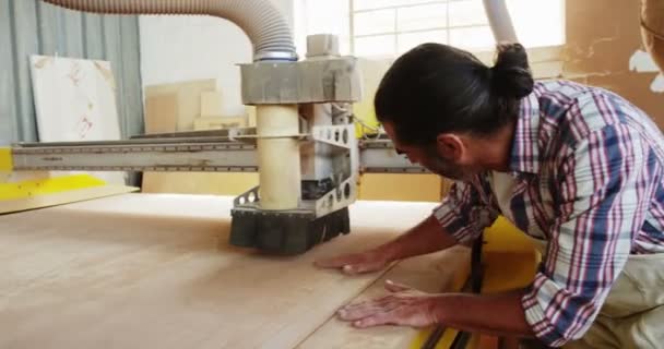 Carpintero usando la máquina y sonriendo para la cámara — Vídeo de stock