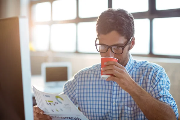 Male business executive reading newspaper — Stock Photo, Image