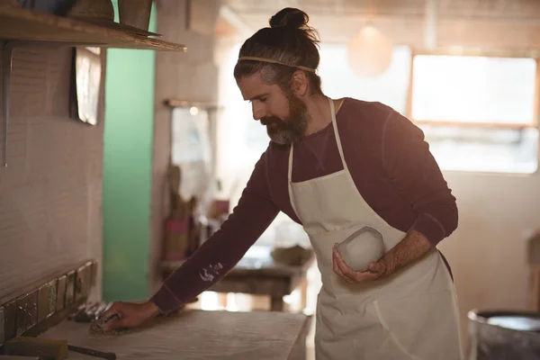 Potter drží clay a čištění tabulky — Stock fotografie