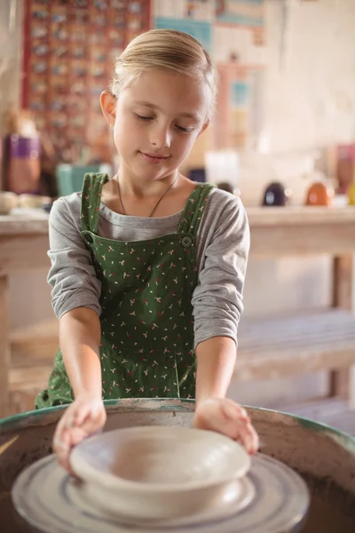 Happy girl making pot — Stock Photo, Image