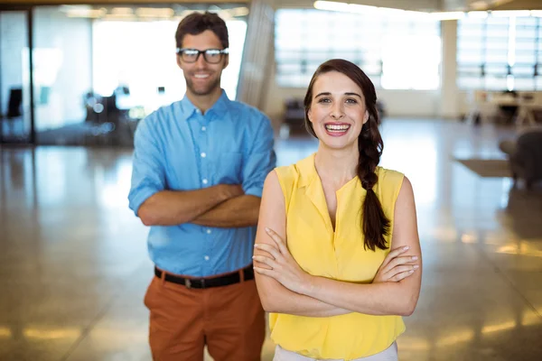 Business executive and co-worker standing