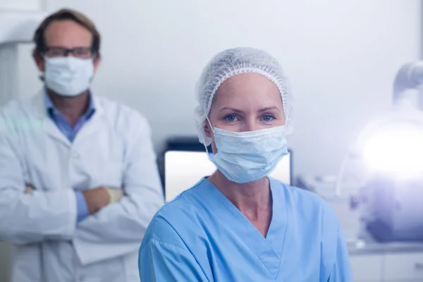 Portrait of dentist and dental assistant wearing surgical mask — Stock Photo, Image