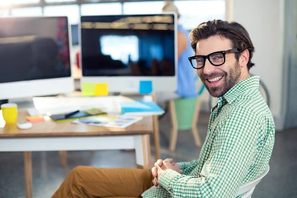 Graphic designer sitting on chair in office — Stock Photo, Image