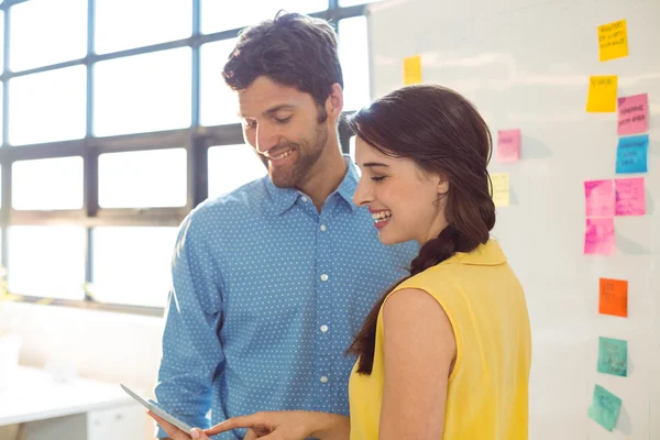 Business executive and co-worker using digital tablet — Stock Photo, Image