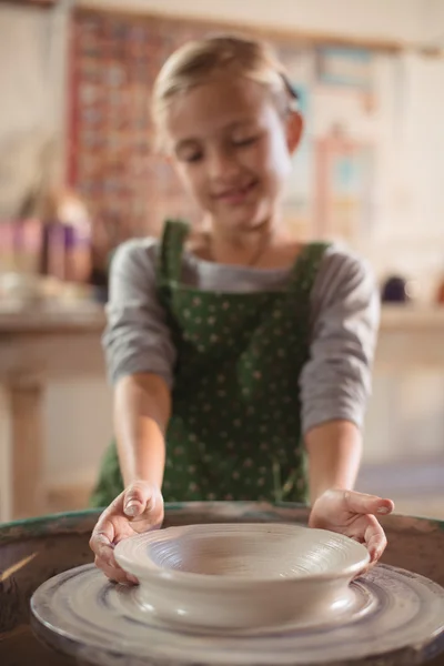 Happy girl making pot — Stock Photo, Image