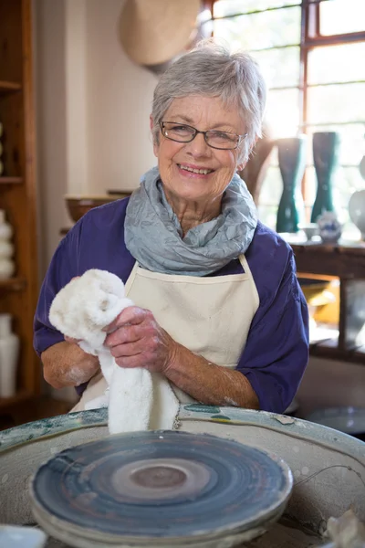 Female potter wiping hand with napkin — Stock Photo, Image