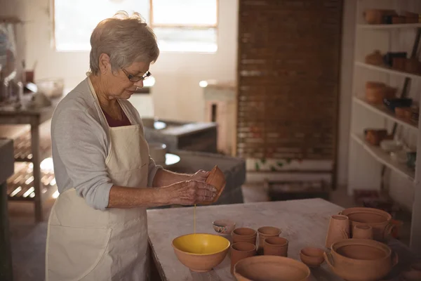 Bayan potter suluboya kabın içinde dökme — Stok fotoğraf