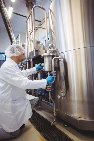 Manufacturer working at storage tanks in brewery — Stock Photo, Image