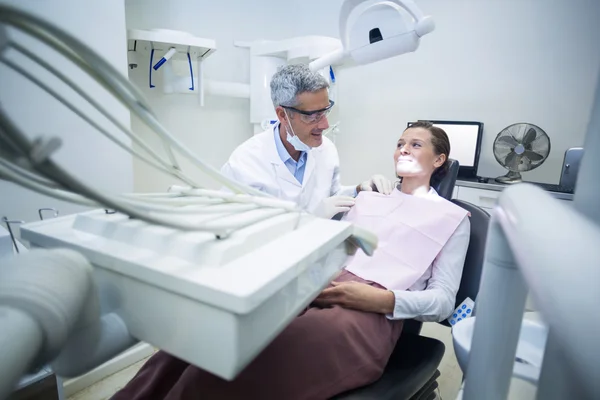 Dentista sorridente che parla al paziente — Foto Stock