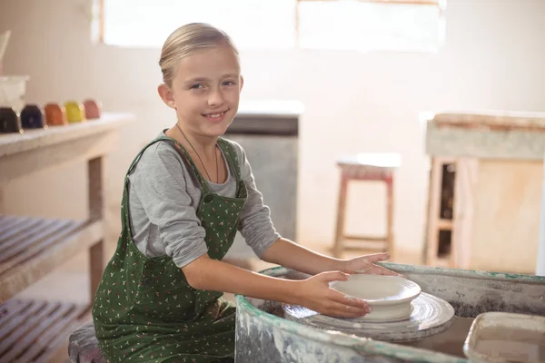 Happy girl making pot — Stock Photo, Image