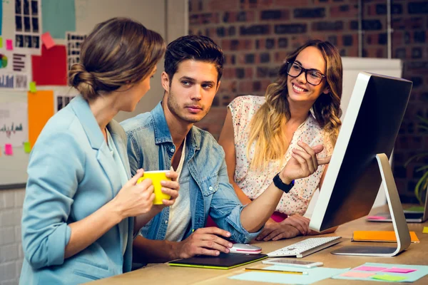 Graphic designers discussing over computer — Stock Photo, Image