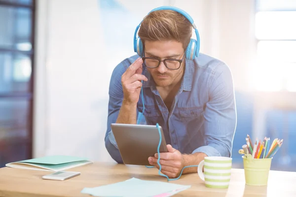 Business executive listening to music on tablet — Stock Photo, Image