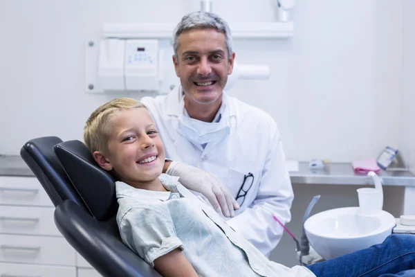 Retrato de dentista sonriente y paciente joven — Foto de Stock