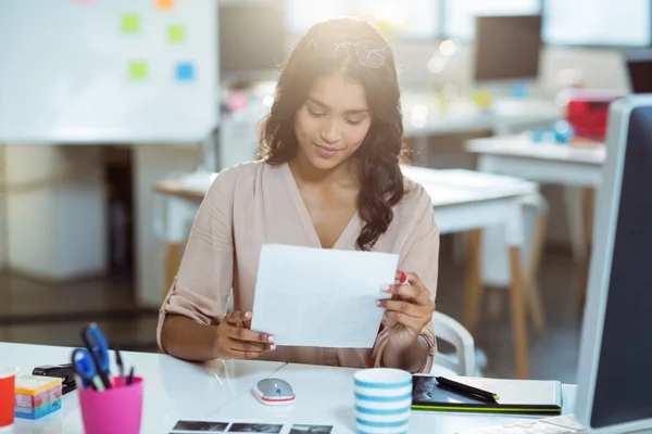 Graphic designer looking at color swatch — Stock Photo, Image