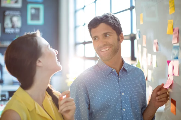 Business executive and co-worker interacting — Stock Photo, Image