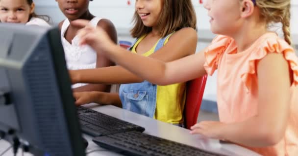 Schoolgirls using computer in classroom — Stock Video