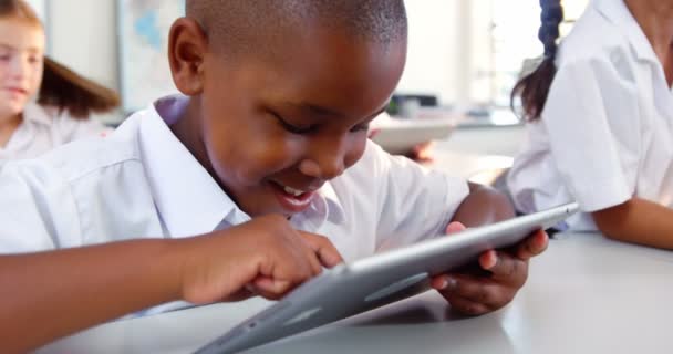 Schoolboy usando tablet digital na sala de aula — Vídeo de Stock