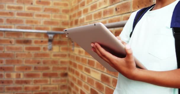 Schoolboy using digital tablet in school — Stock Video