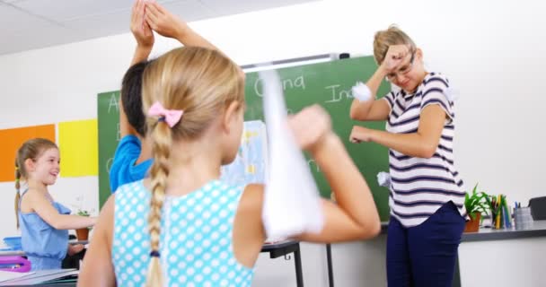 School kids throwing paper balls on teacher — Stock Video