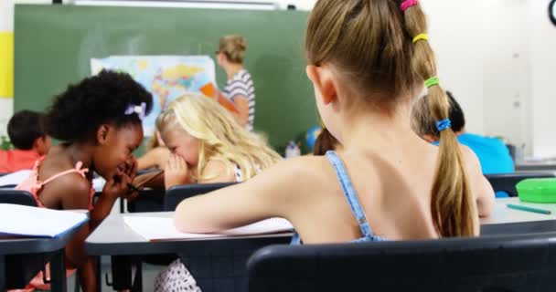 Colegiala haciendo la tarea en el aula — Vídeos de Stock