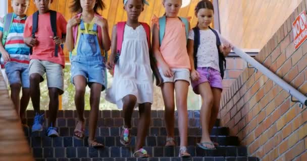 Group of kids getting down from staircase — Stock Video