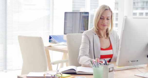 Businesswoman working over computer — Stock Video