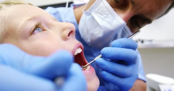 Dentist examining a young patient — Stock Video