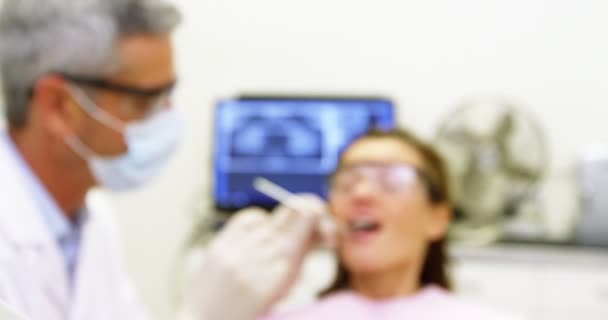 Dentist examining a female patient — Stock Video