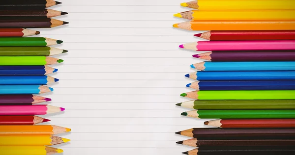 Colorful crayons against clipboard — Stock Photo, Image