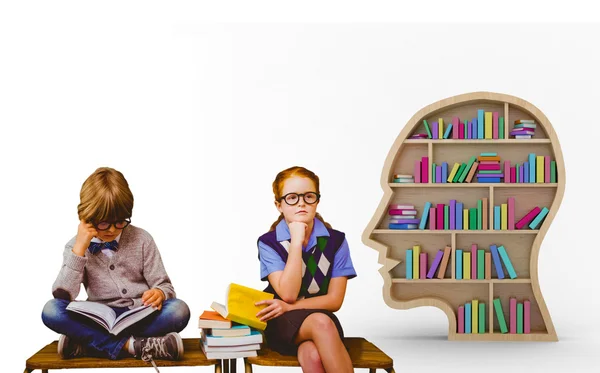 Pupils studying against colorful books — Stock Photo, Image