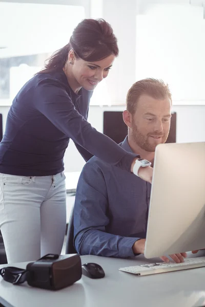 Teacher assisting student in computer room — Stock Photo, Image