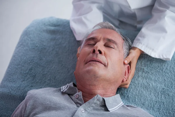 Hombre mayor recibiendo masaje en el cuello de fisioterapeuta —  Fotos de Stock