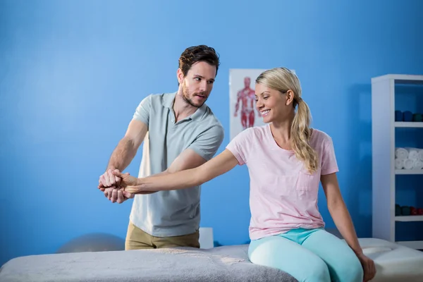 Physiotherapist massaging hand of patient — Stock Photo, Image
