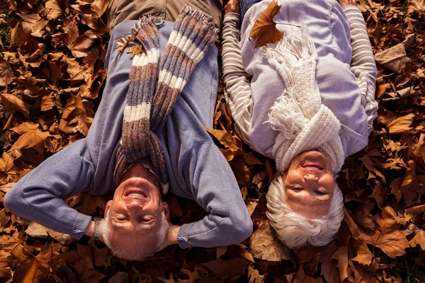 Äldre par liggande på marken — Stockfoto