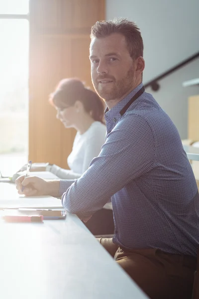 Mature student writing notes — Stock Photo, Image