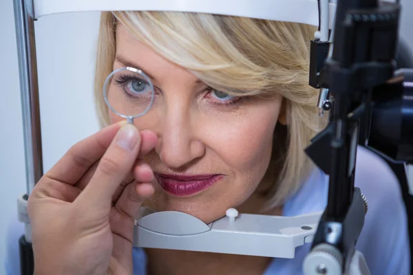 Female patient under going eye test on slit lamp — Stock Photo, Image