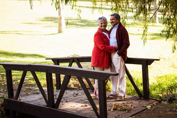 Pareja abrazando mientras de pie en pasarela —  Fotos de Stock