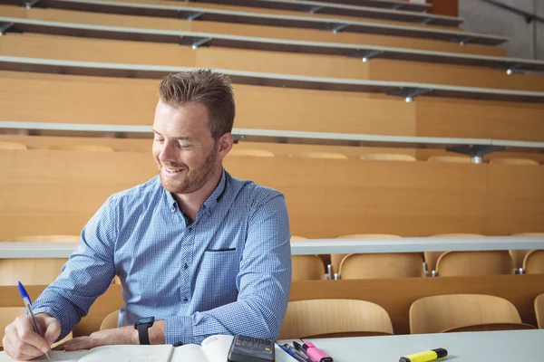 Mature student writing notes — Stock Photo, Image