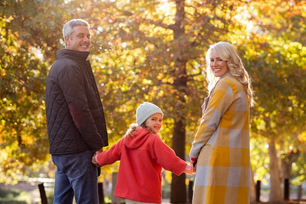 Happy family against trees — Stock Photo, Image