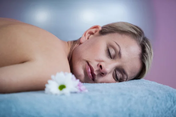 Beautiful woman lying on a massage bed — Stock Photo, Image