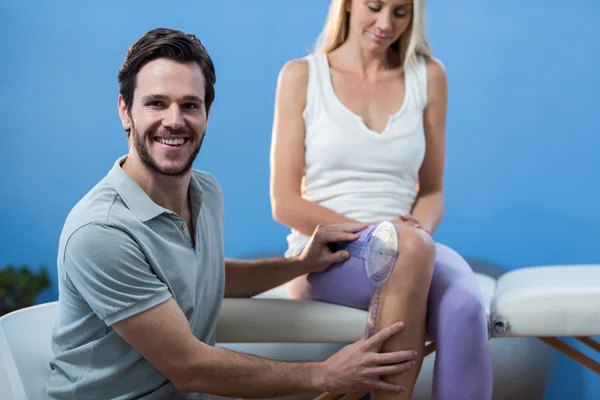 Фізіотерапевт вивчає жіноче коліно — стокове фото