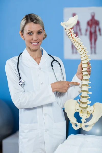 Retrato del fisioterapeuta que sostiene el modelo de columna vertebral — Foto de Stock