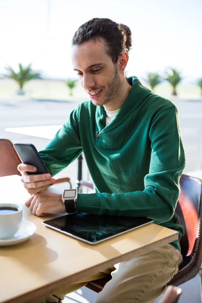 Un barbat care foloseste telefonul mobil cu tableta digitala si o ceasca de cafea — Fotografie, imagine de stoc