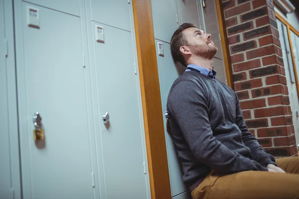 Stressed mature student sitting in locker room — Stock Photo, Image