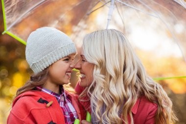 Mother and daughter rubbing noses clipart