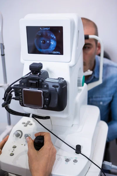 Man looking at eye test machine