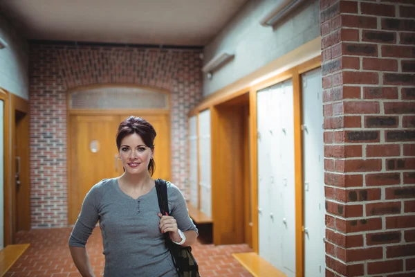 Mature student standing in locker room — Stock Photo, Image