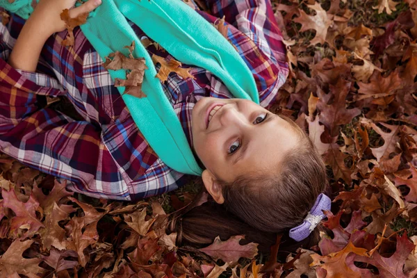 Lachende meisje liggen in het park — Stockfoto