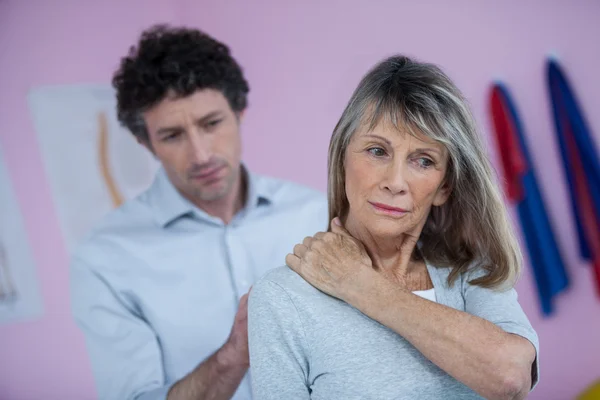 Fisioterapeuta dando masaje de cuello a paciente femenina — Foto de Stock