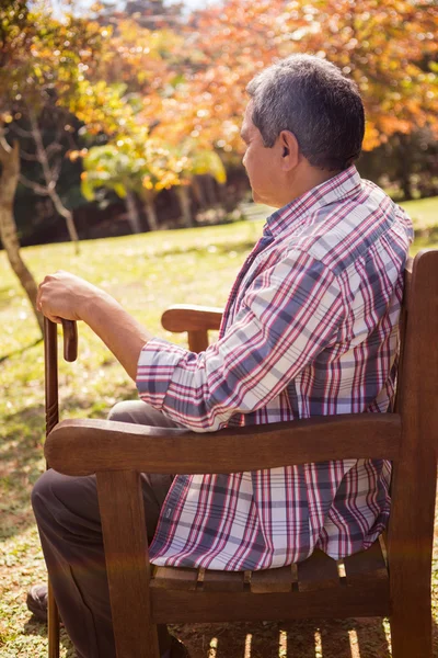 Elderly man on bench with cane — Stock Photo, Image